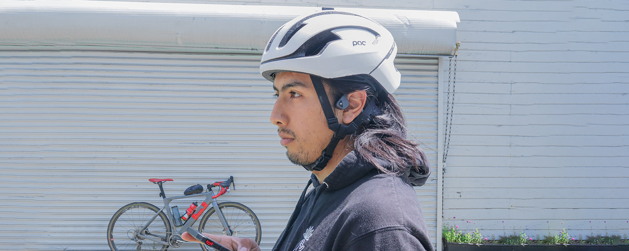Man wearing bike helmet and AfterShokz Air wireless headphones