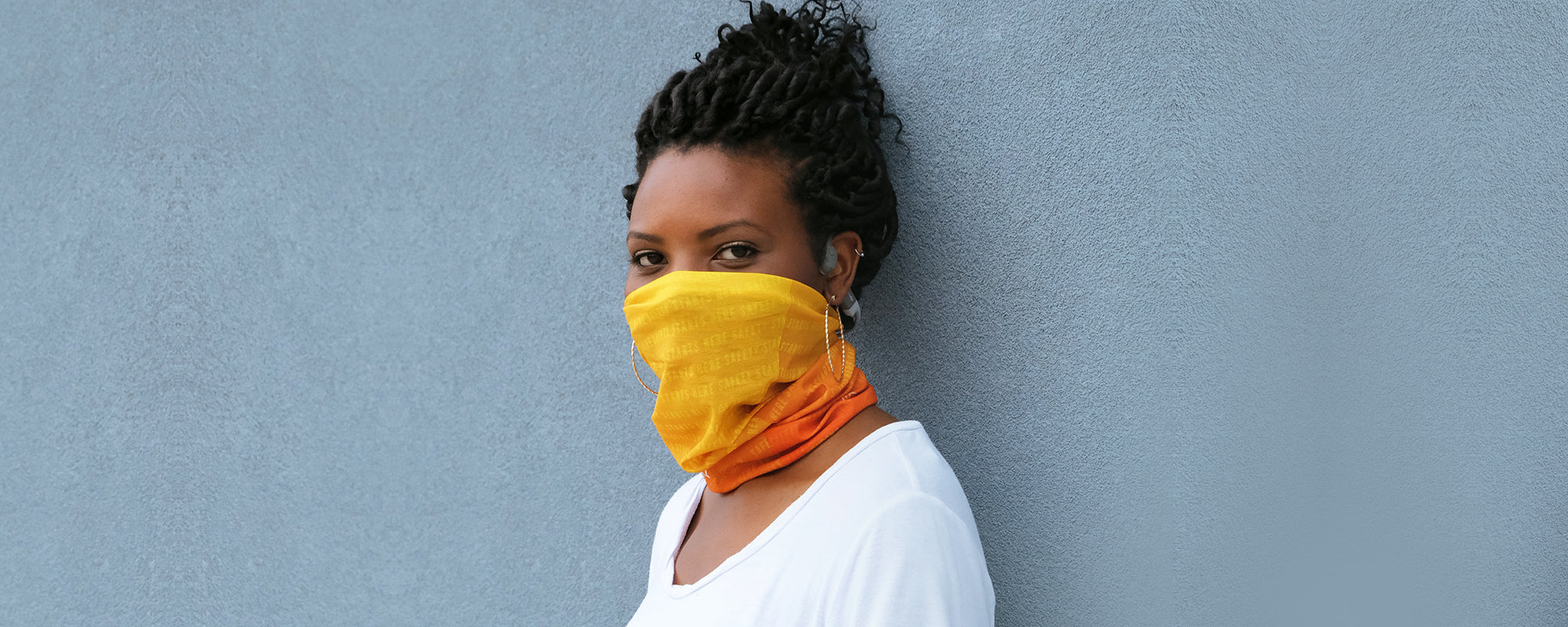 Woman wearing AfterShokz multifunctional headwear as face covering
