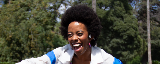 Woman wearing Shokz OpenMove wireless headphones while listening to music