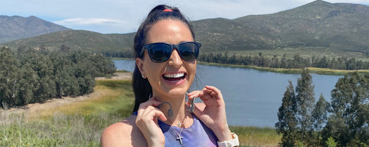 Woman putting on AfterShokz Aeropex wireless headphones