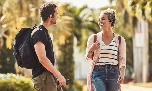 College students wearing Trekz Air and Trekz Titanium headphones