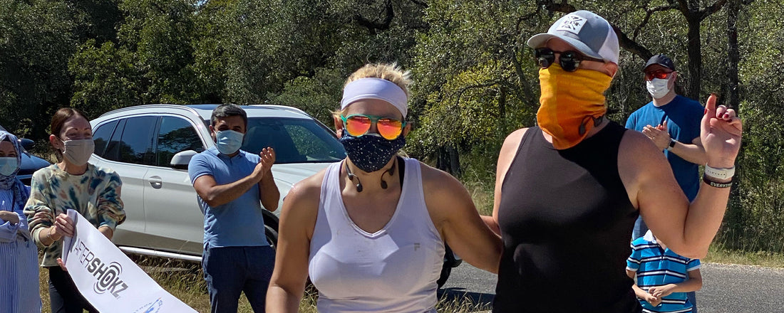 Kristen (left) and AfterShokz Marketing VP Kim Fassetta (right) wearing AfterShokz wireless headphones