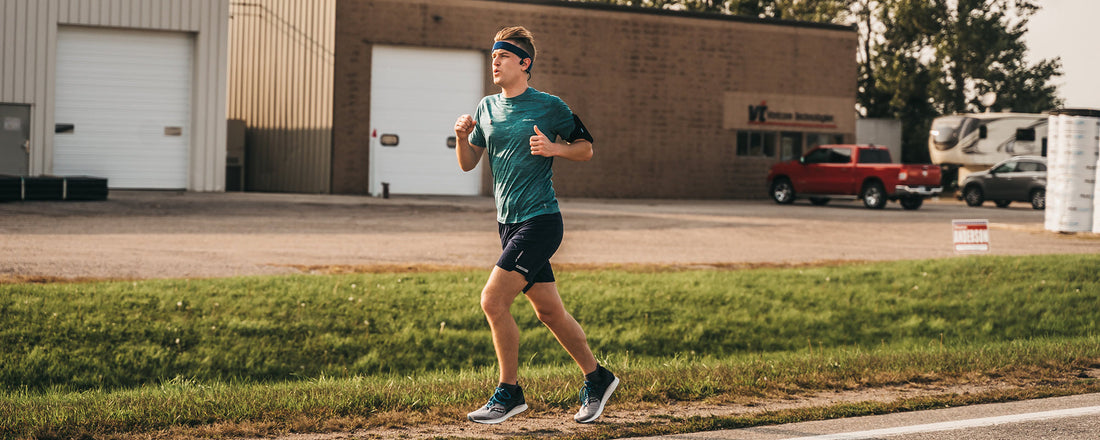 Mikah Meyer running while wearin AfterShokz headphones