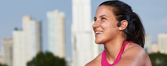 Paralympic athlete Lacey Henderson wearing AfterShokz Aeropex headphones